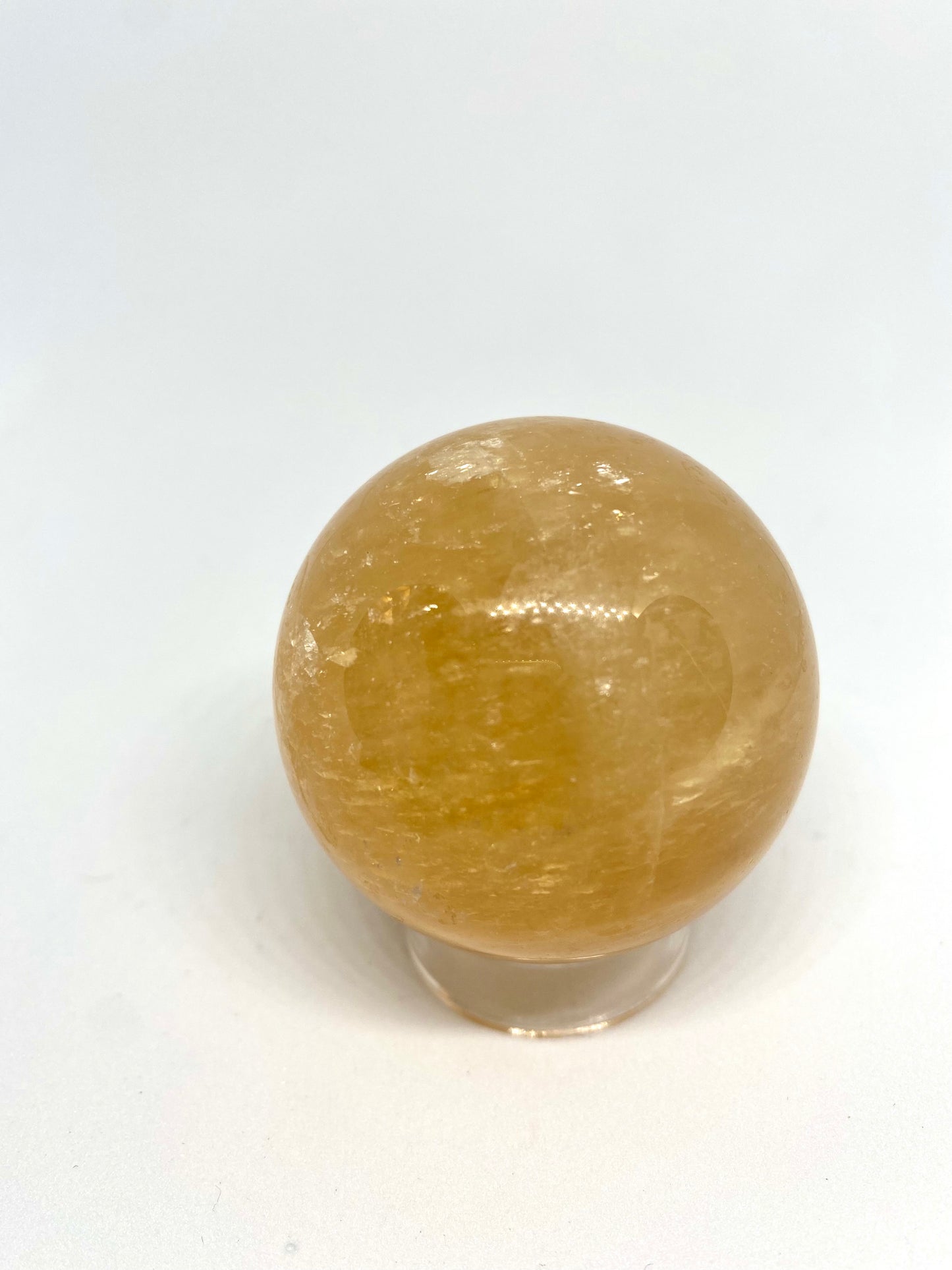 Honey calcite sphere with rainbows