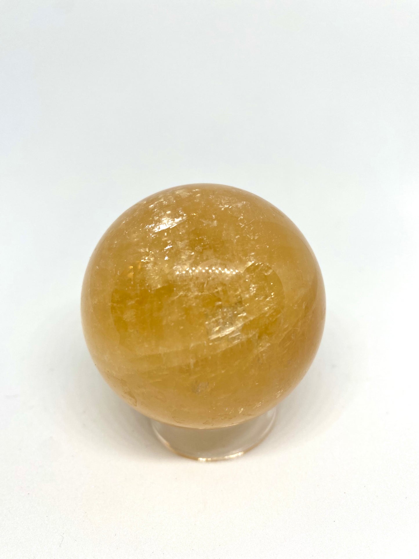 Honey calcite sphere with rainbows