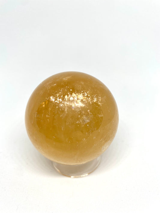 Honey calcite sphere with rainbows